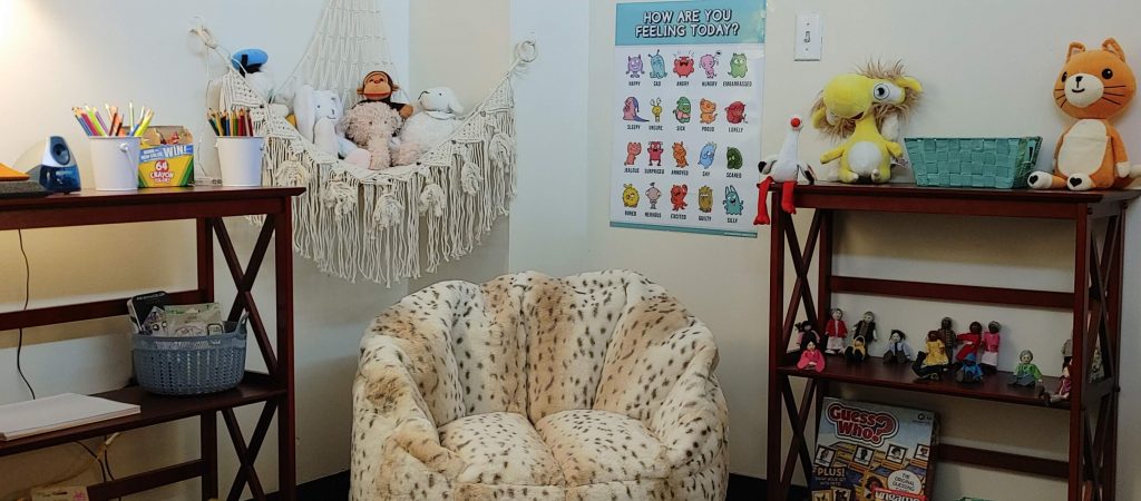 Child therapy materials picturing art supplies, toys and a comfy bean bag chair.